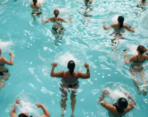 a group fitness class doing swimming pool workouts