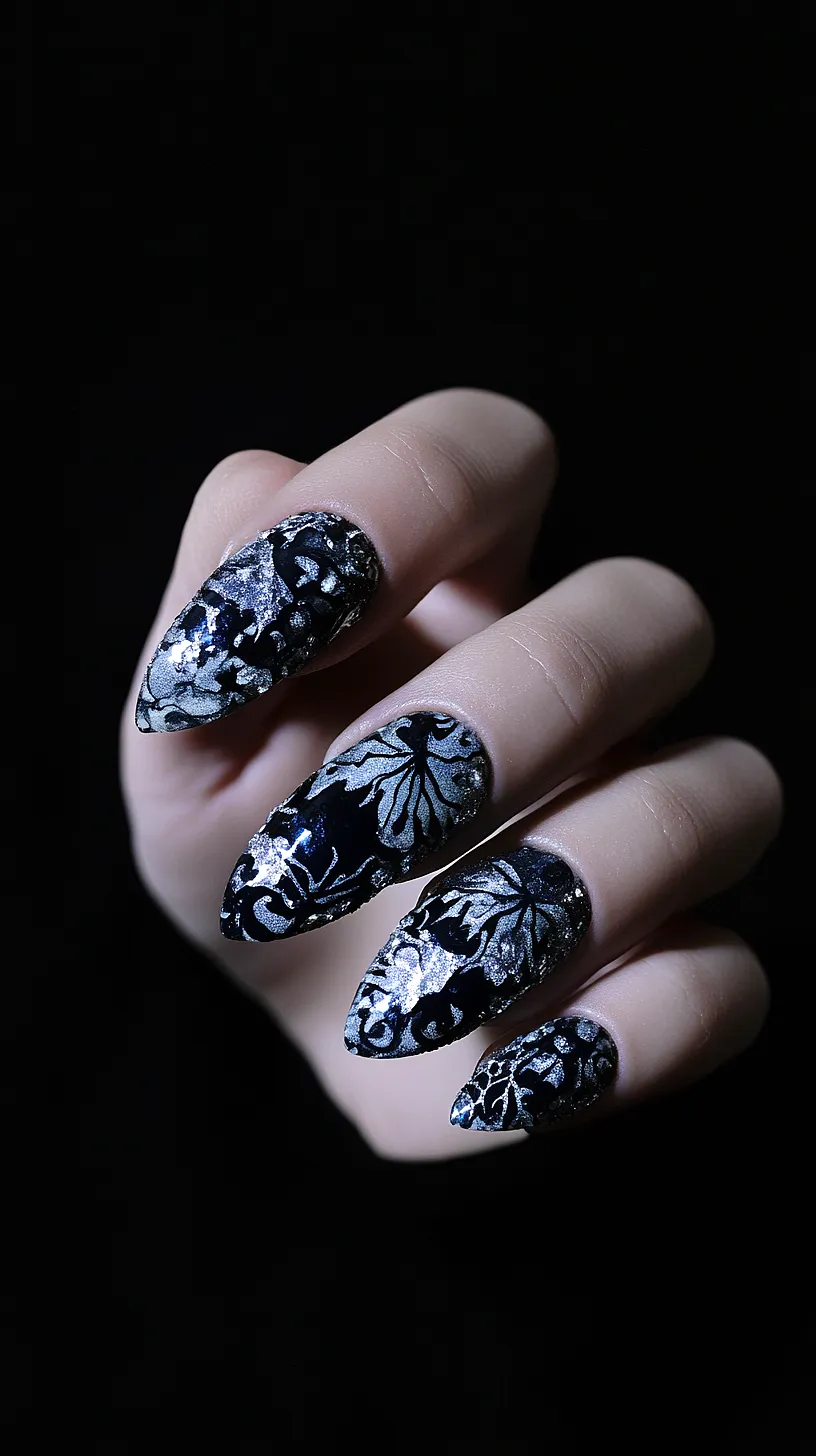 25+ Aesthetic Sea Witchery Nails You Will Adore 7 Long, pointed nails with a black and silver floral design, featuring intricate patterns for an edgy look, and a glossy finish for added drama.