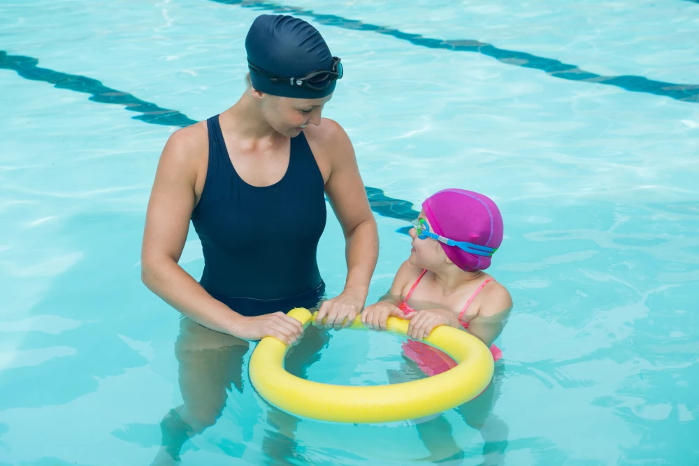 Early Swim Lessons for Kids: How Water Supercharges the Growing Brain 2 indoor pool swim coaching child focus development